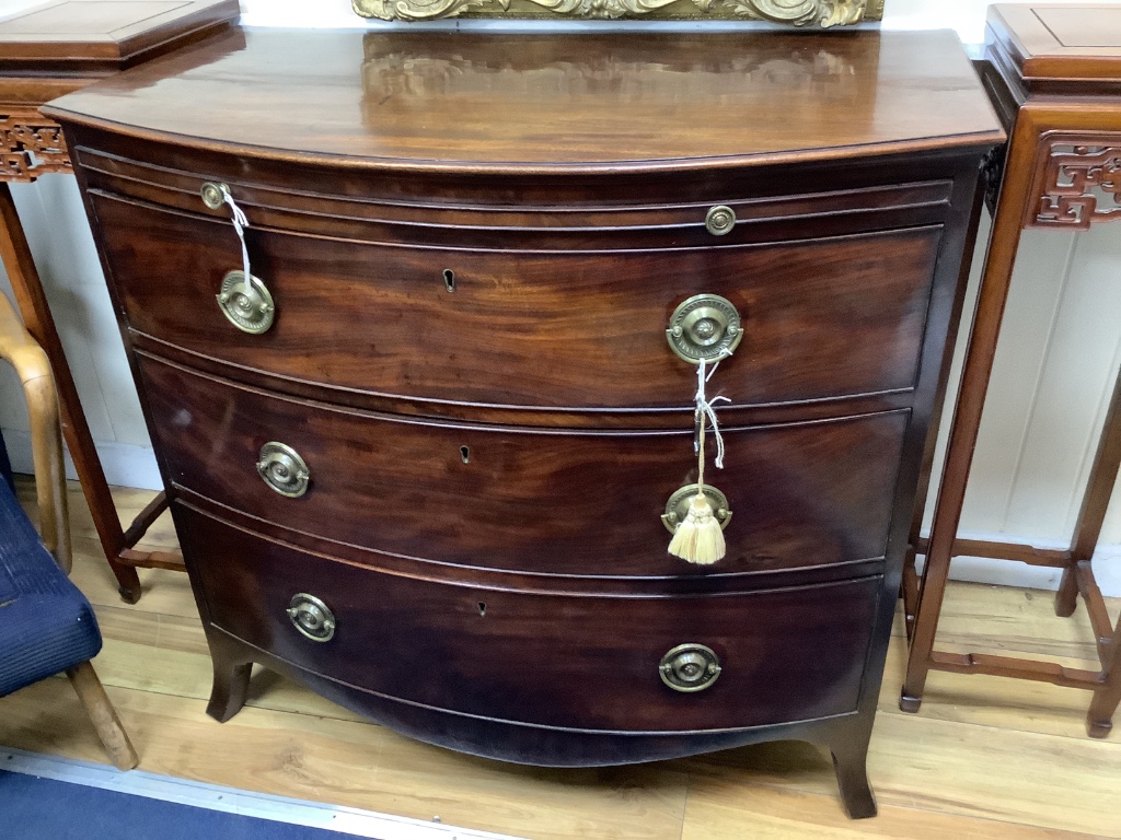 A late Georgian bow-fronted mahogany chest with brushing slide, width 94cm, depth 54cm, height 88cm